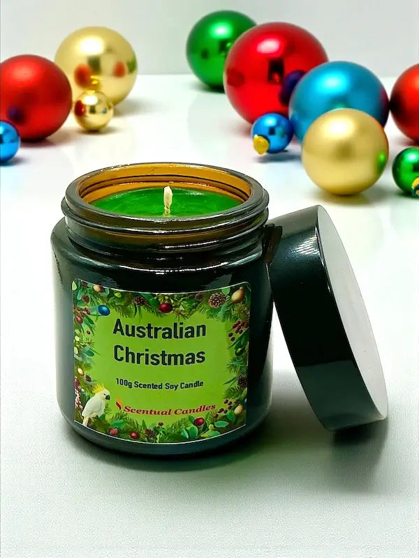 Australian Christmas scented soy candle with festive decorations in the background.