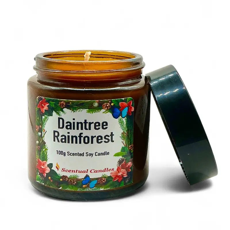 Scentual Candles Daintree Rainforest Pine scented candle with label and lid open on a white background