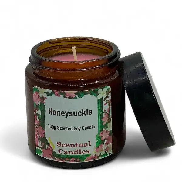Scented soy candle in an amber jar with a floral label on a white background