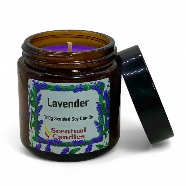 Lavender scented candle in an amber jar with a black lid on a white background