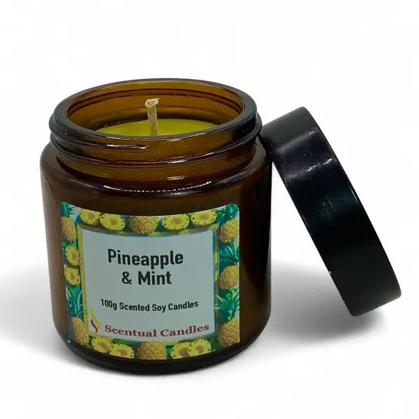 Scented candle in a brown jar with a pineapple and mint label on a white background