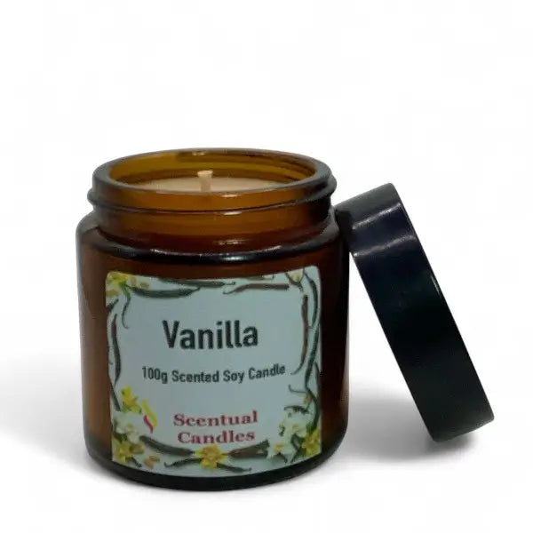 Vanilla scented soy candle in an amber jar with a black lid on a white background