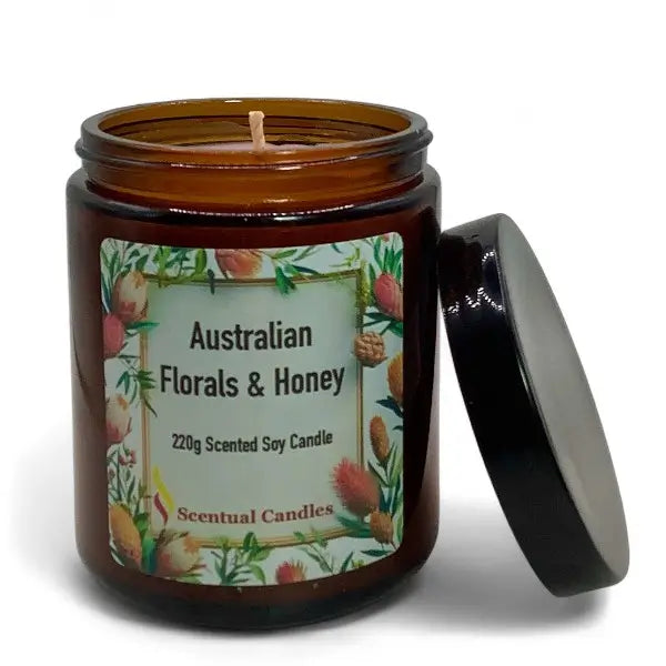 Scented soy candle in an amber jar with a floral label on a white background