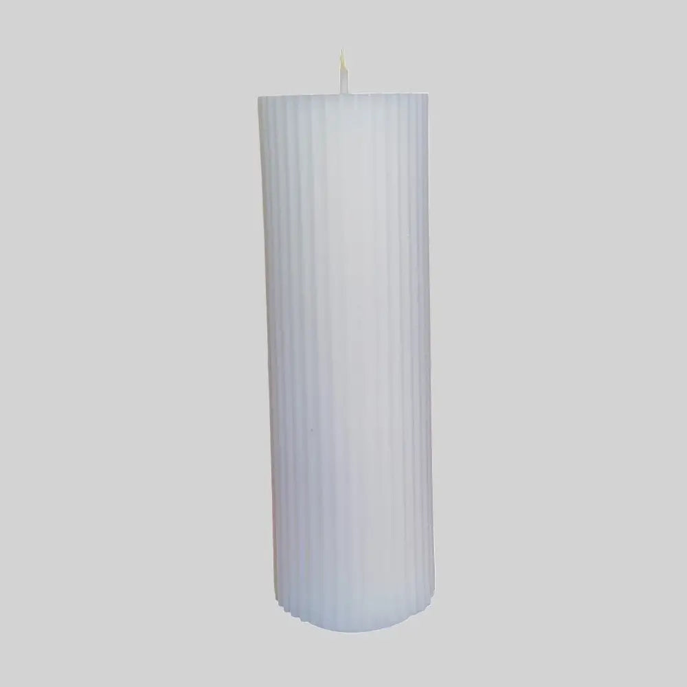 Cylindrical white candle with ribbed texture on a light gray background