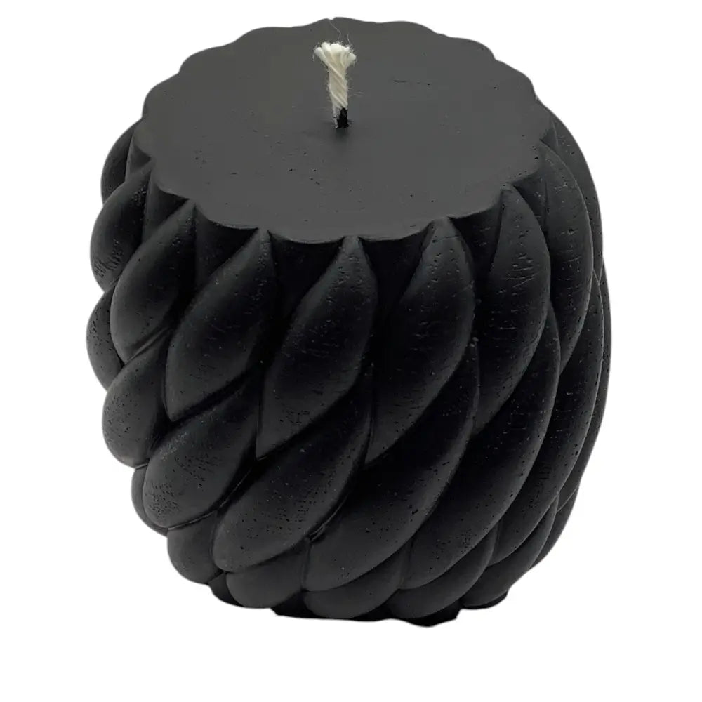 Black ball of yarn candle on white background