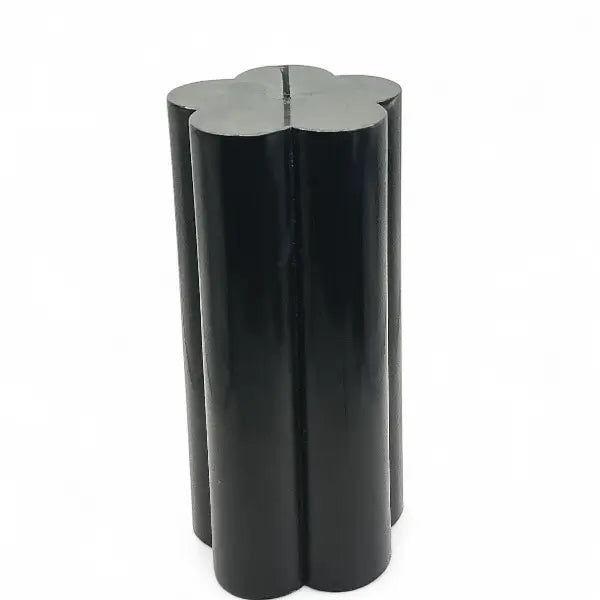 Black flower shaped candle on a white background