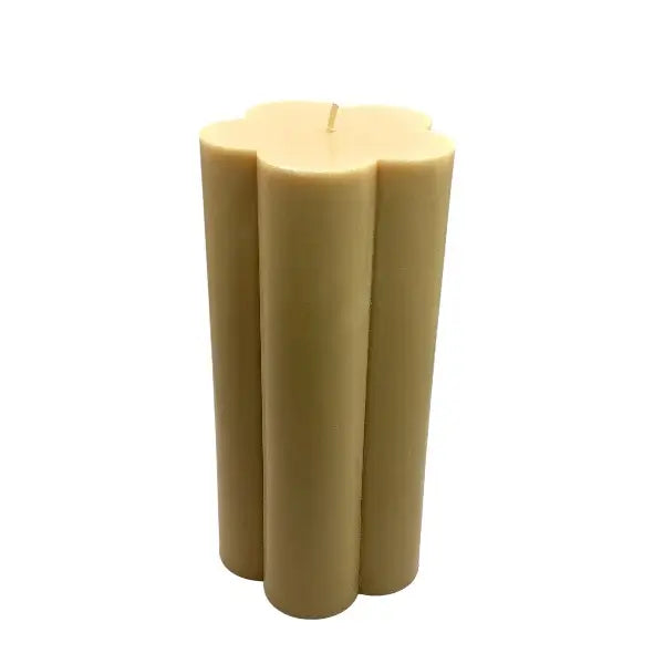 Beige candle with a unique design on a white background