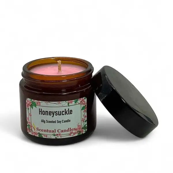 Scented candle in a jar labeled 'Honeysuckle' by Scentual Candles on a white background