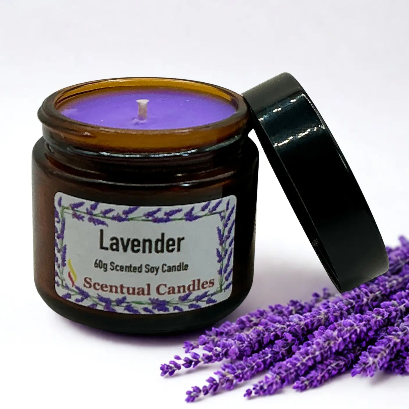Lavender scented candle in a brown jar with lavender flowers on a white background