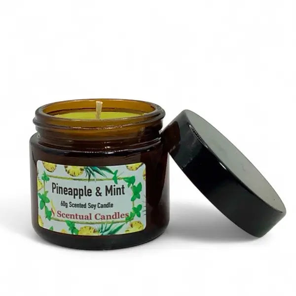 Scentual Candles pineapple & mint candle in amber jar with black lid on white background