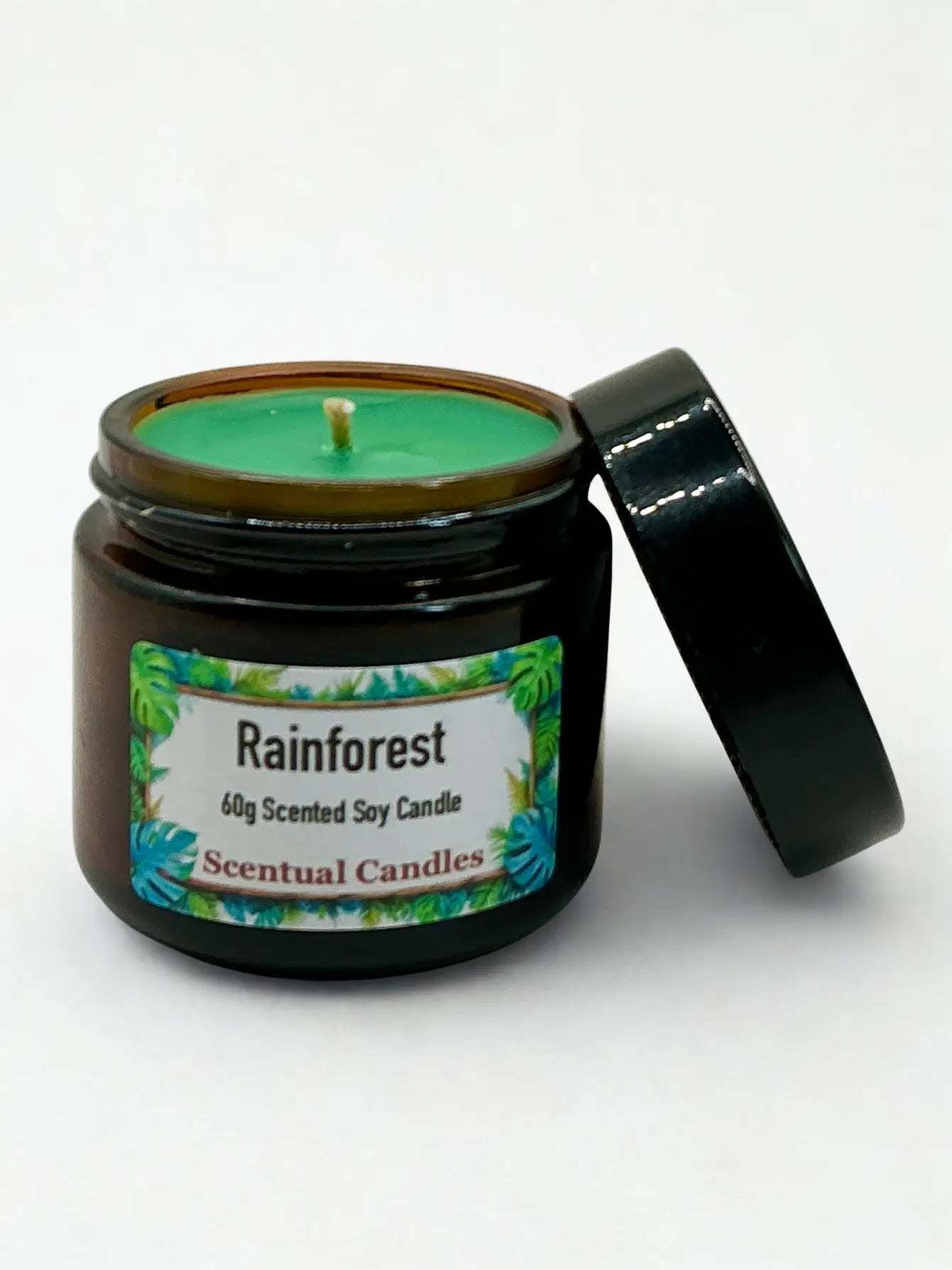 Scentual candles jar labeled 'Rainforest' on a white background