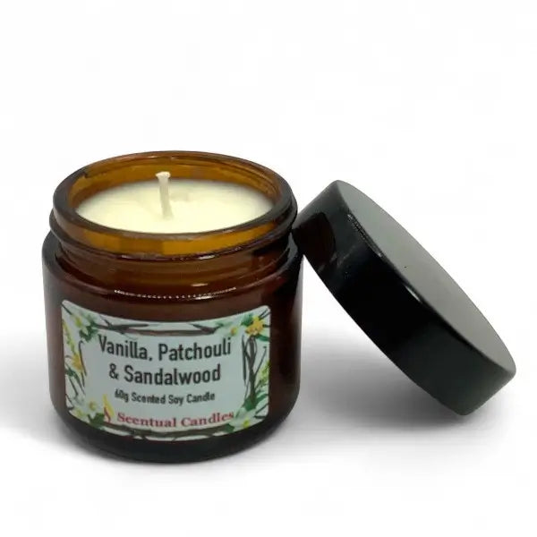 Scentual candles jar with a lit candle and black lid on a white background