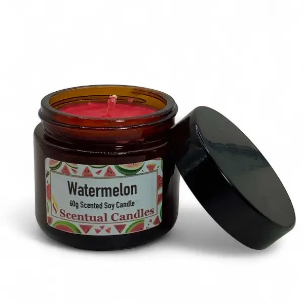 Watermelon scented candle in an amber jar with a black lid on a white background