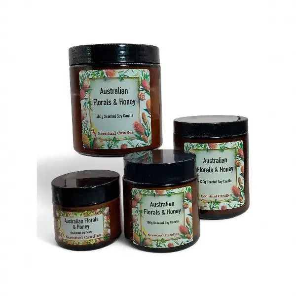 Set of four 'Australian Florals & Honey' candles with decorative labels on a white background