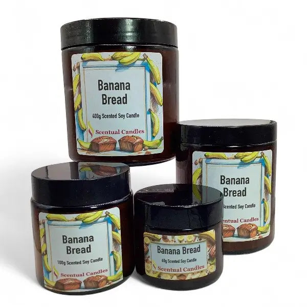 Four 'Banana Bread' scented candles of different sizes on a white background
