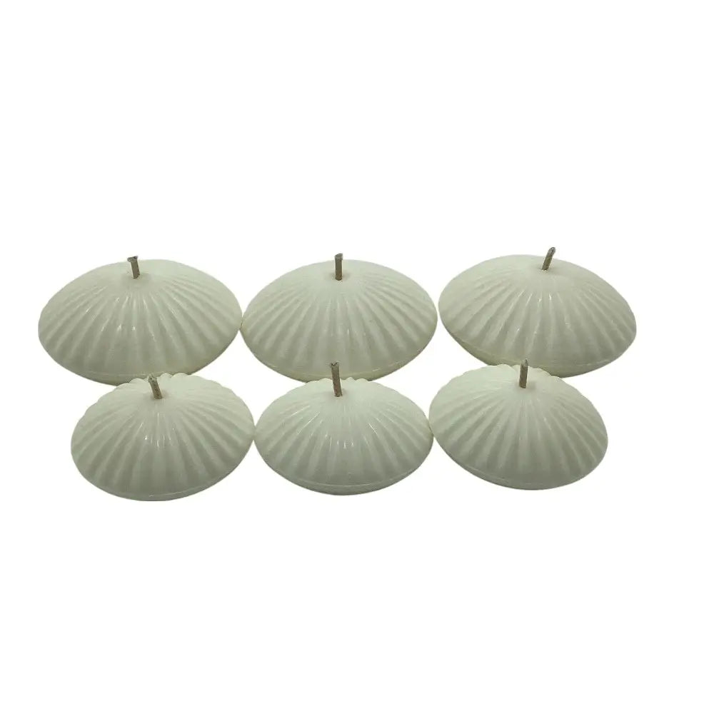 Set of six ribbed floating candles on a white background