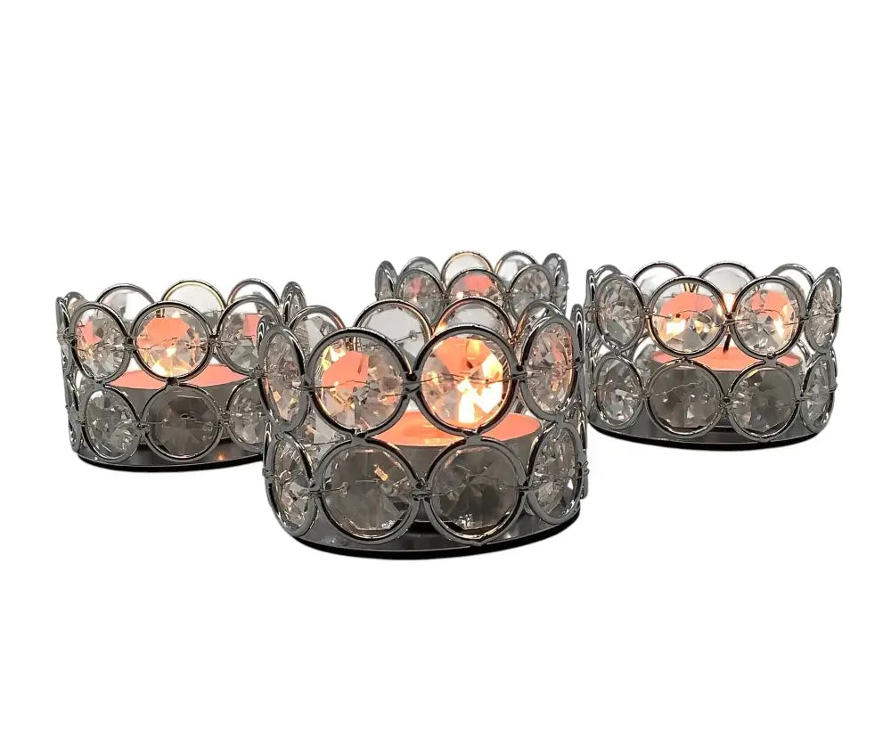 Set of three decorative candle holders with crystal-like embellishments on a white background