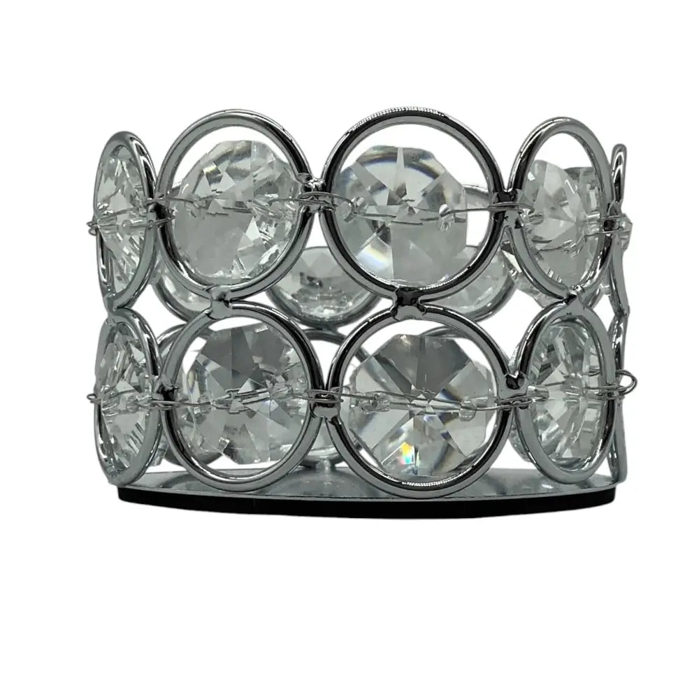 Decorative candle holder with crystal-like stones on a white background
