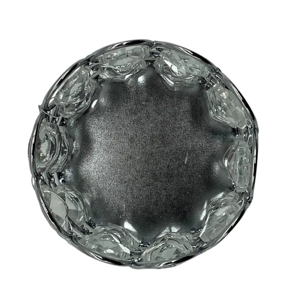 Clear glass candle holder with decorative edge on a white background