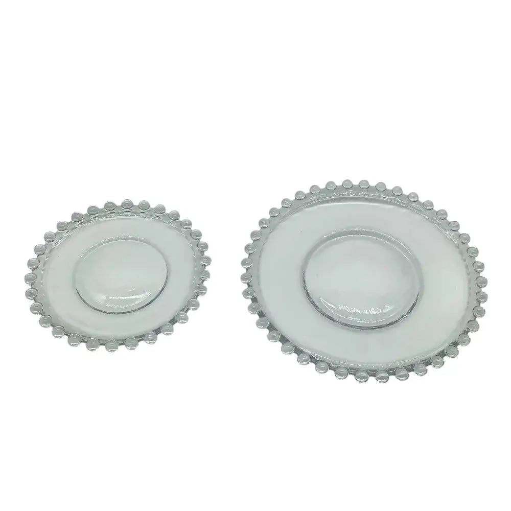 Two round glass plates with decorative rims on a white background