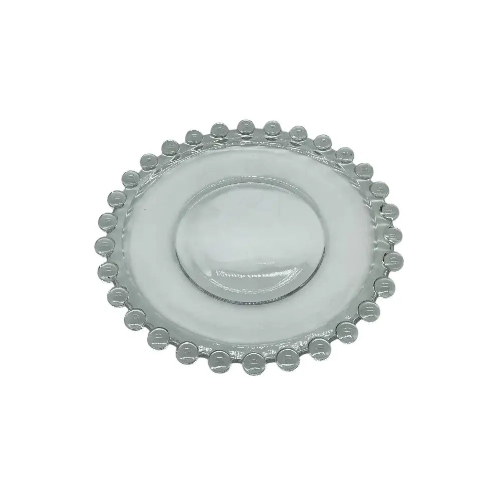 Clear glass plate with decorative edge on a white background