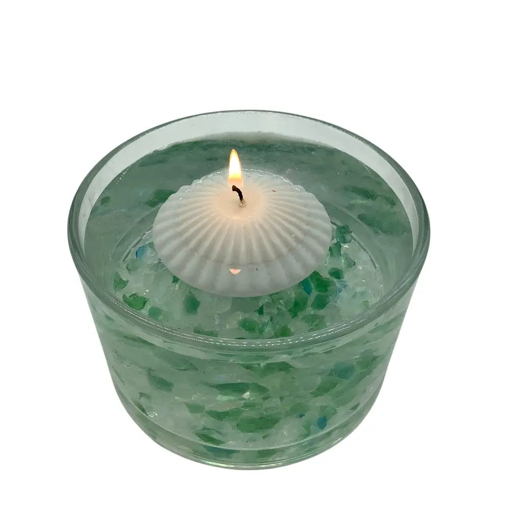 Floating Candle in a glass container of water on a white background