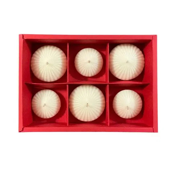 Set of six white spherical candles in a red box