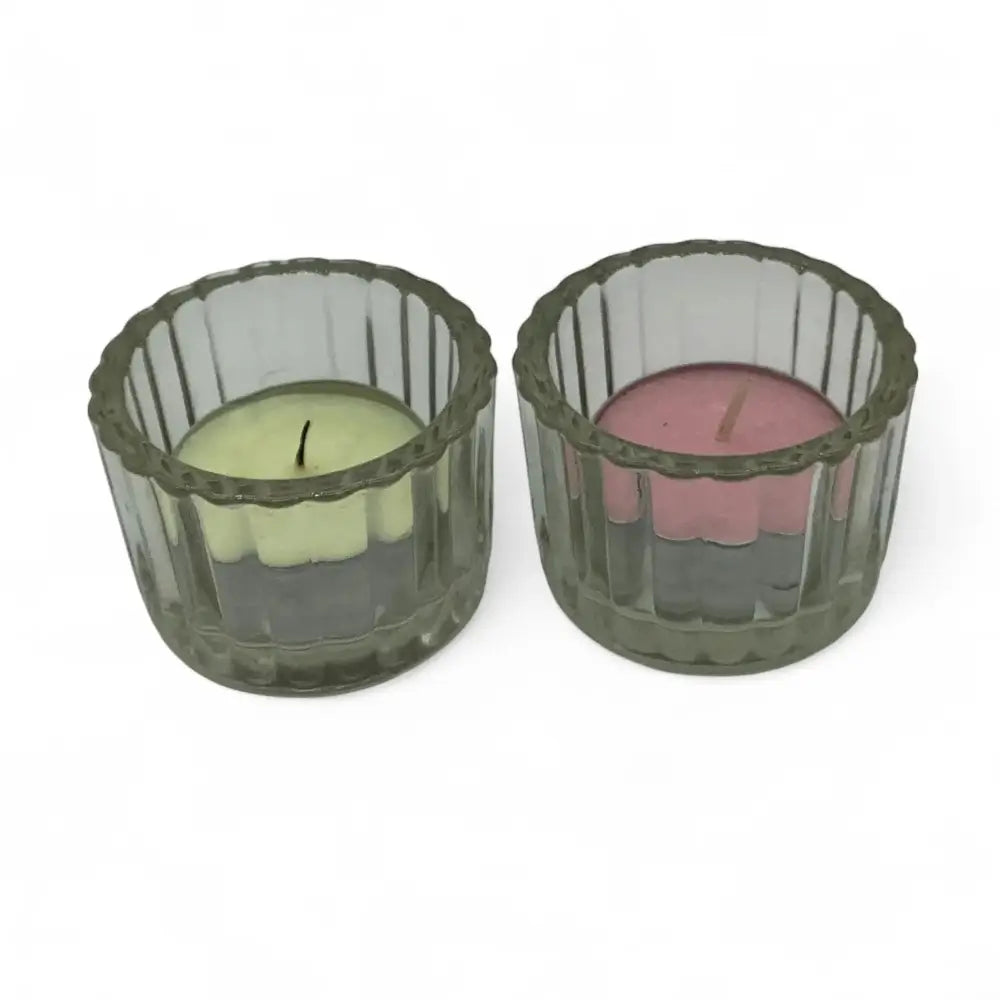 Two candle holders with candles inside on a white background