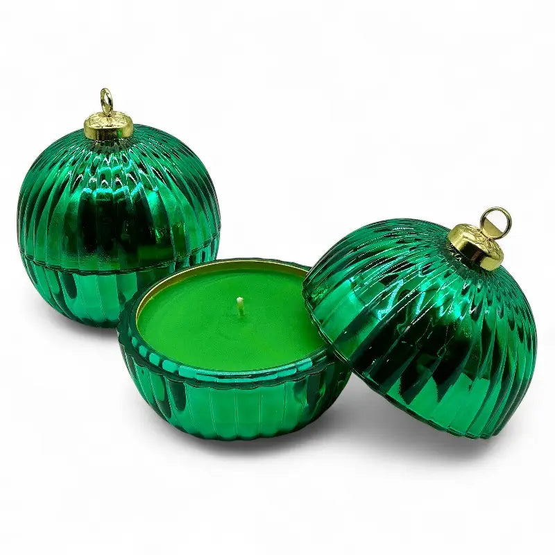 Glass Bauble Christmas scented candles in green, ribbed glass jars with gold tops, perfect for holiday decor and festive fragrance.