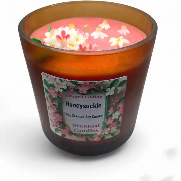 Honeysuckle scented candle with floral label on a white background