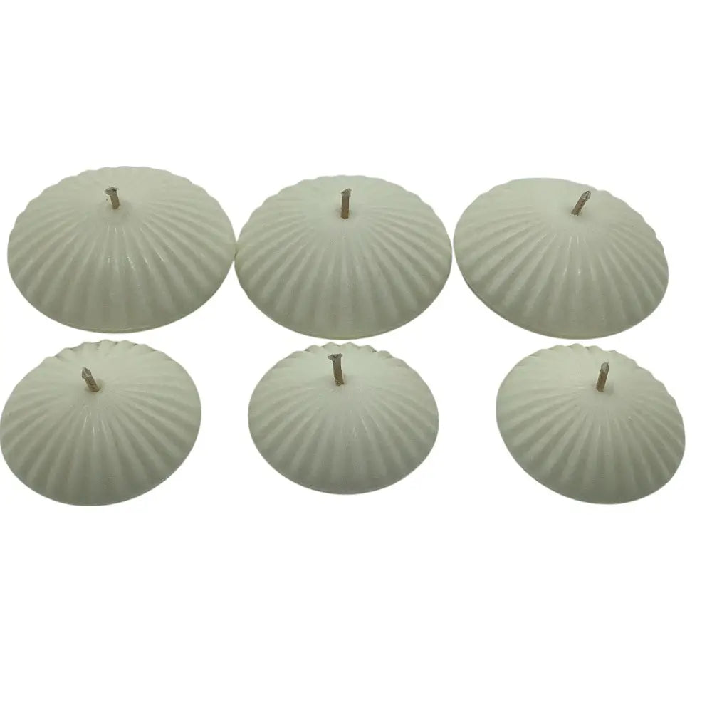 Set of six ribbed floating candles on a white background