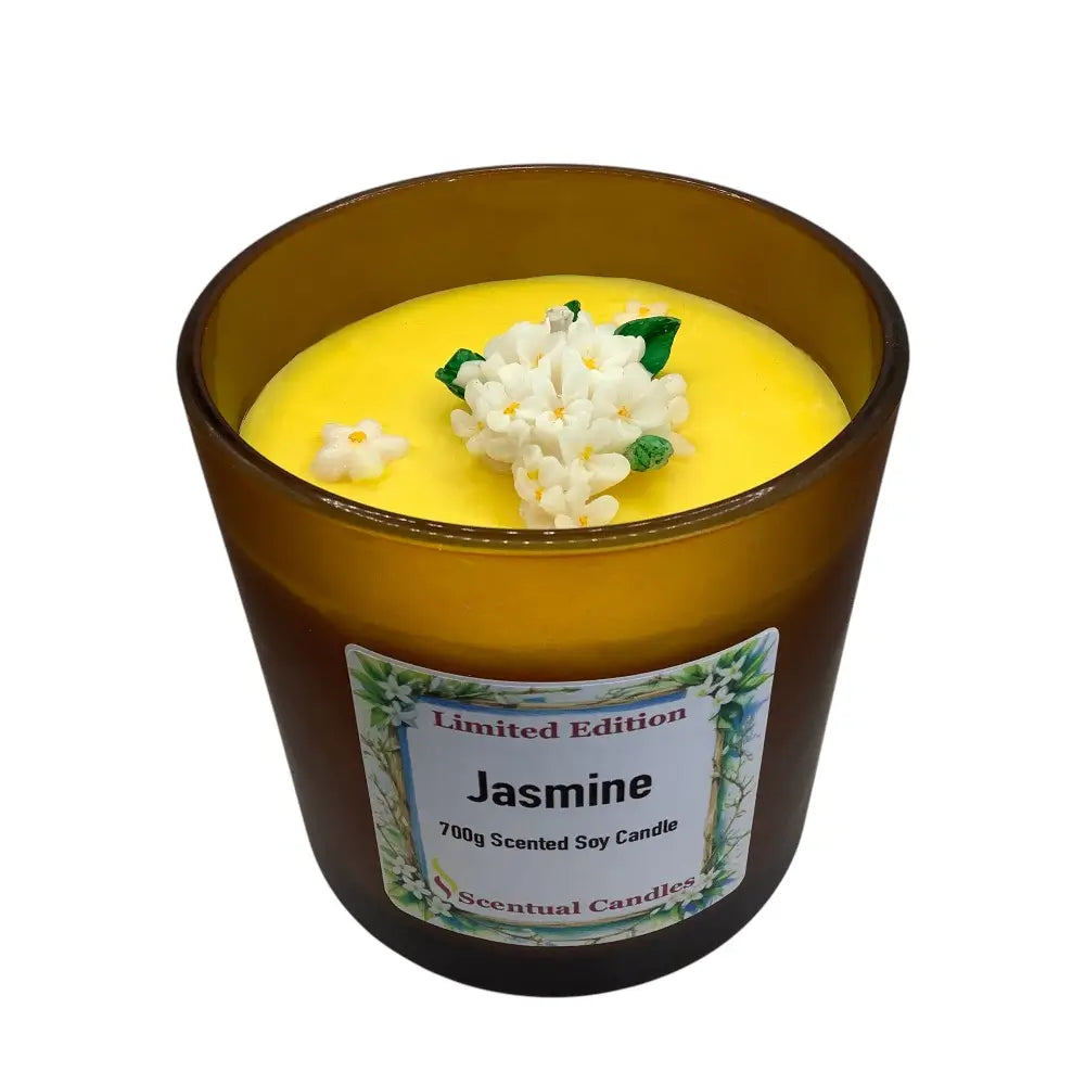 Scented candle labeled 'Jasmine' with a decorative flower on top, on a white background.