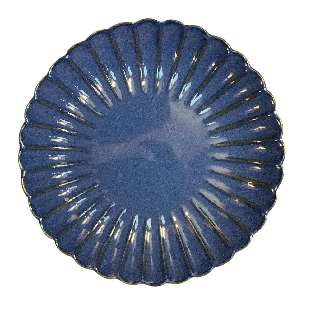 Blue decorative ceramic candle holder plate with a fan-like design on a white background