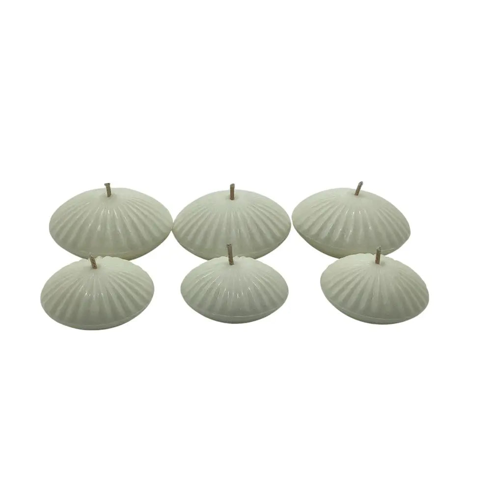 Set of six shell-shaped floating candles on a white background