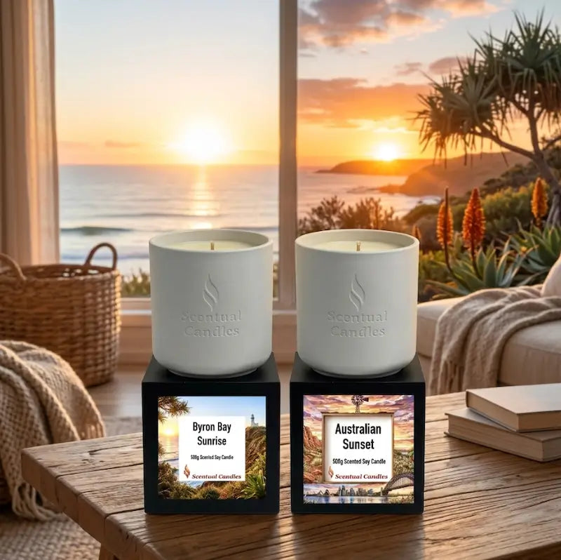 Sunrise and Sunset Australian Scented Candle Duo displayed by a window overlooking the beach during sunset.