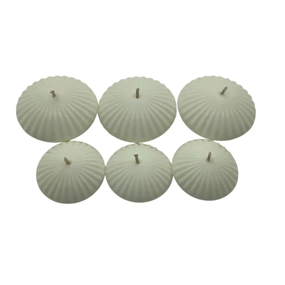 Set of six ribbed floating candles on a white background