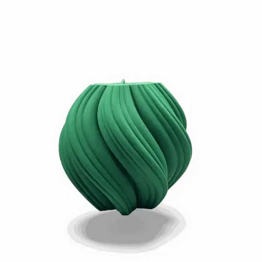 Green textured ball candle on a white background