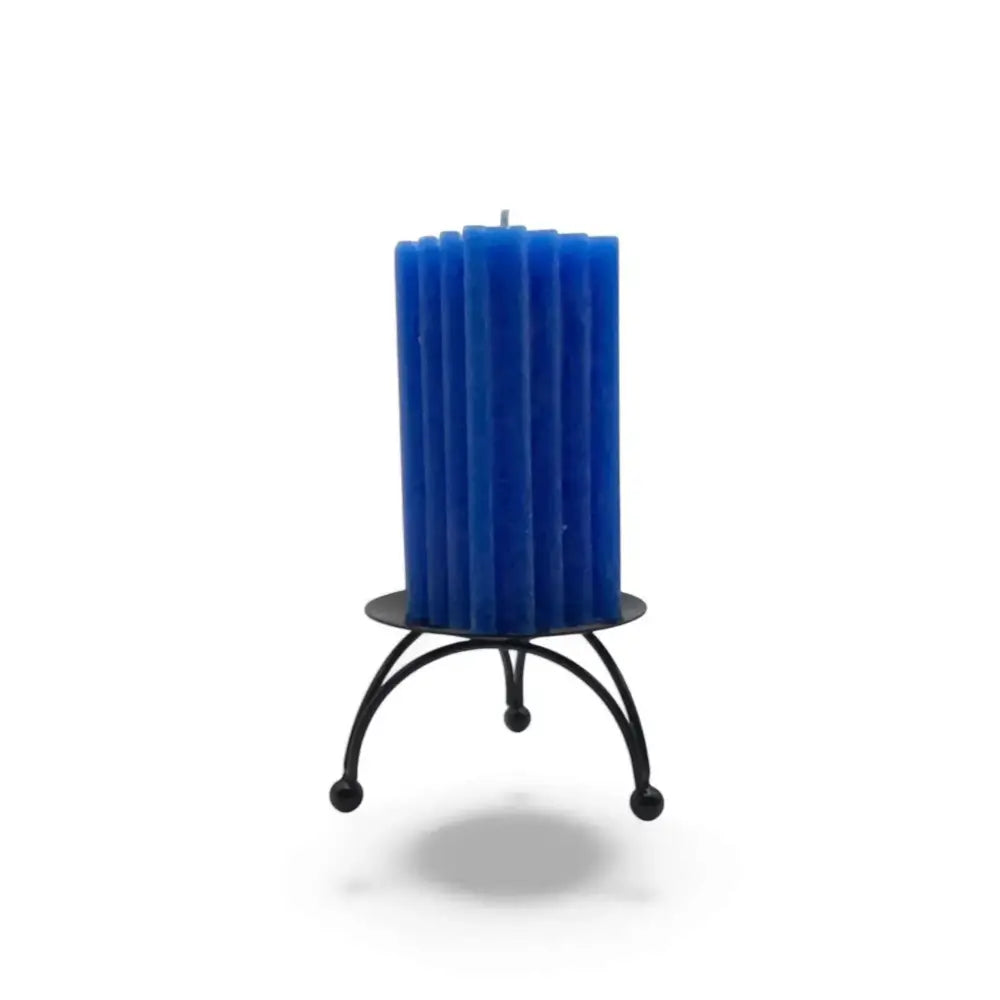 Round black metal candle stand with three-legged geometric base and blue candle.