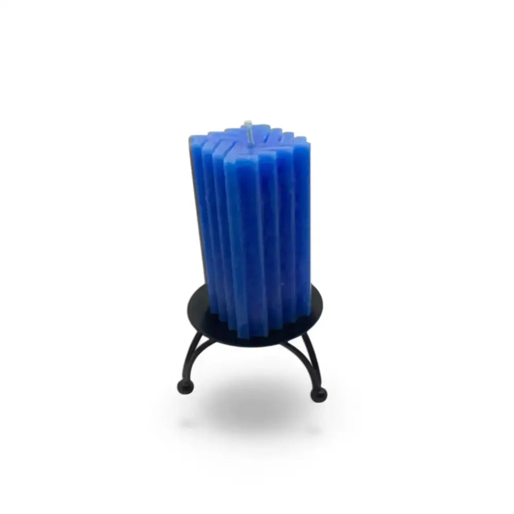 Round black metal candle stand with blue candle on geometric three-legged base.