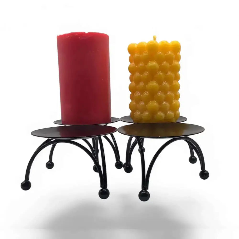 Round black metal candle stand with Nordic design, three-legged base, and matte black plate, displaying two candles.