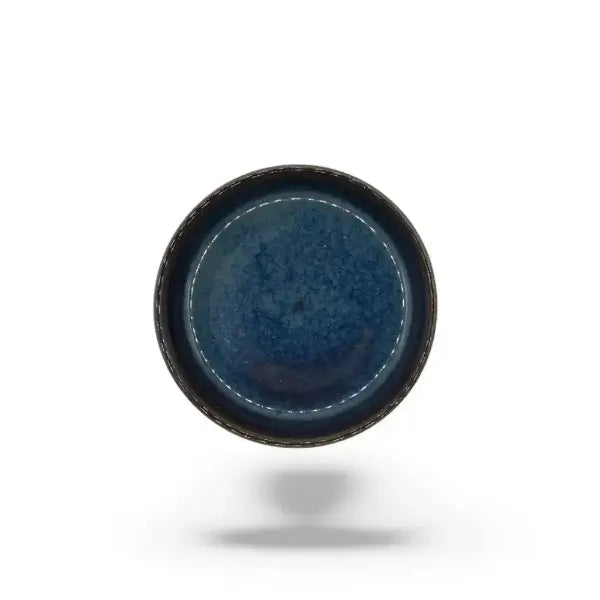Blue ceramic candle holder plate on a white background