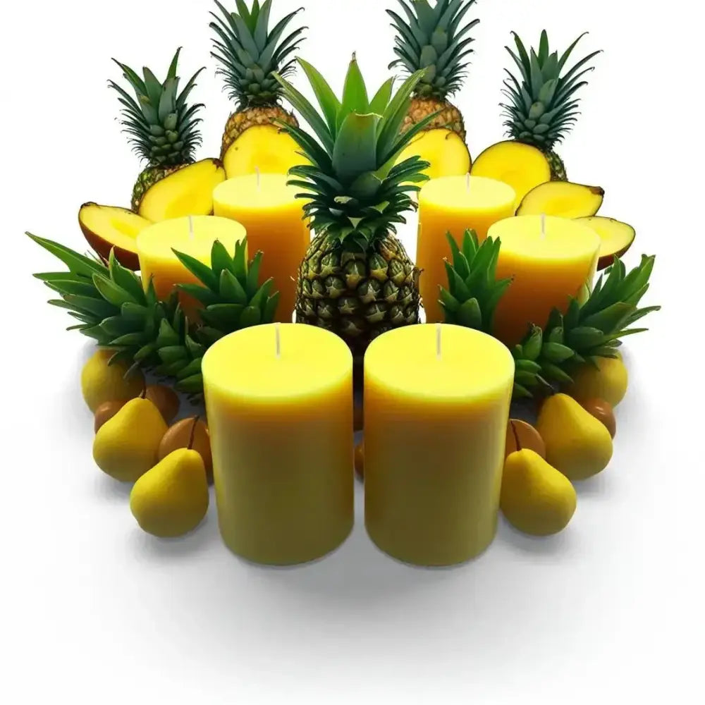 Fruit Scented Soy Candle Set surrounded by fresh pineapple and mango.