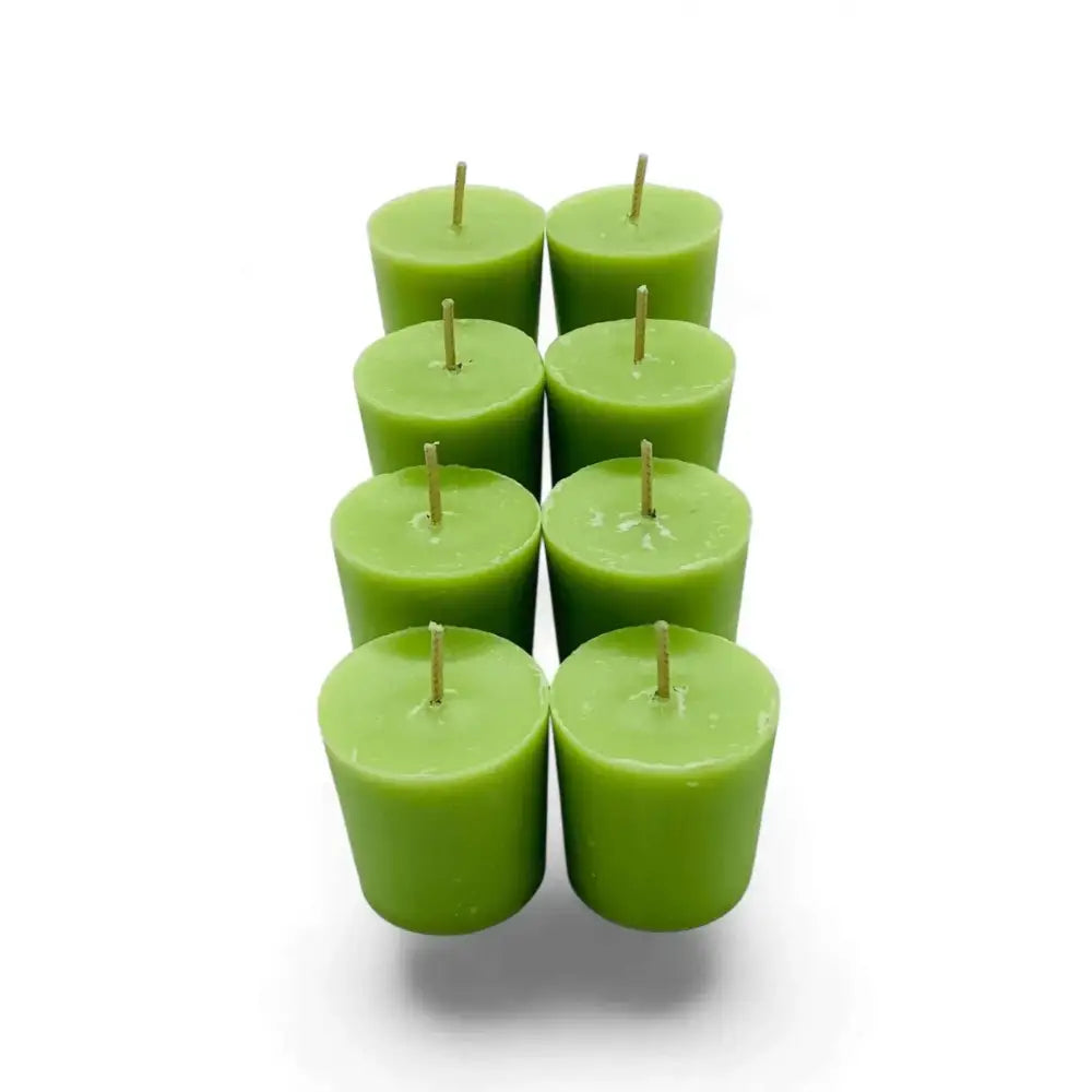 Gardenia Scented Soy Votive Candles in a cluster, showcasing their vibrant green color and smooth finish.