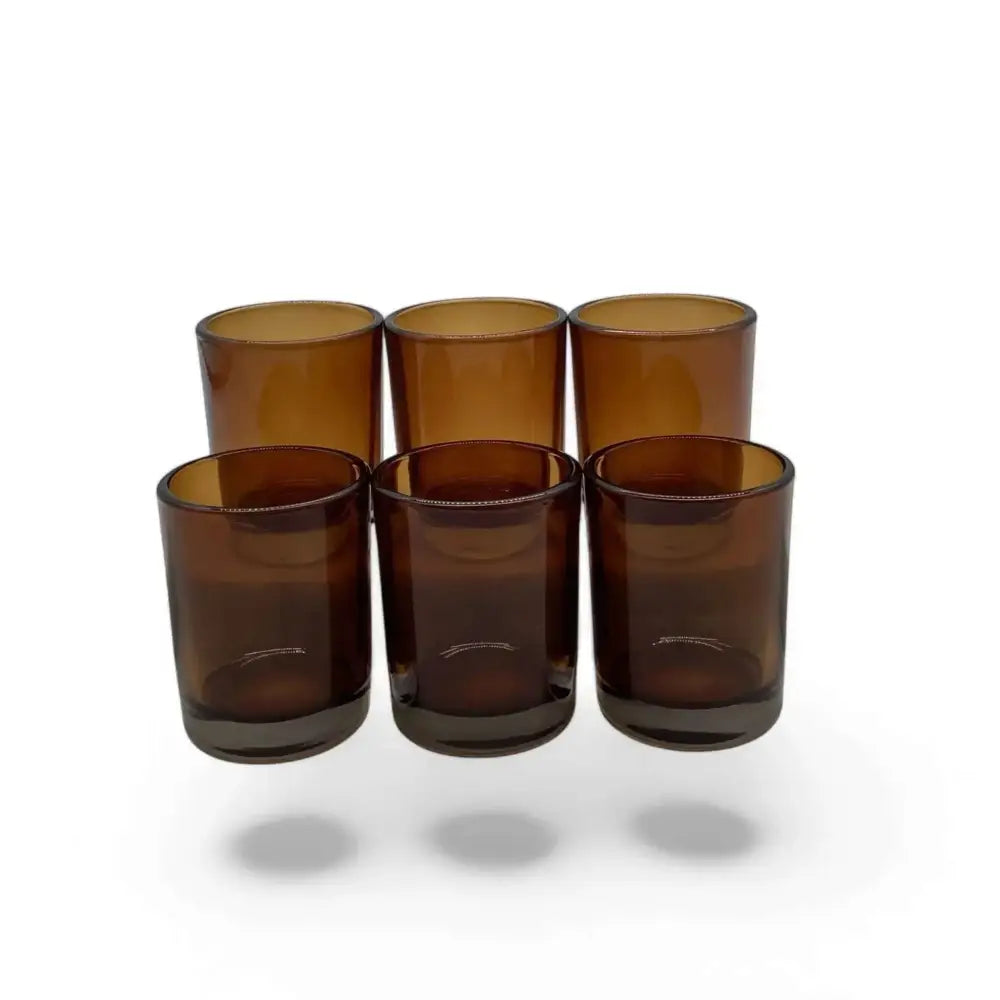 Amber glass votive candle holders in a set, perfect for creating a cozy ambiance.