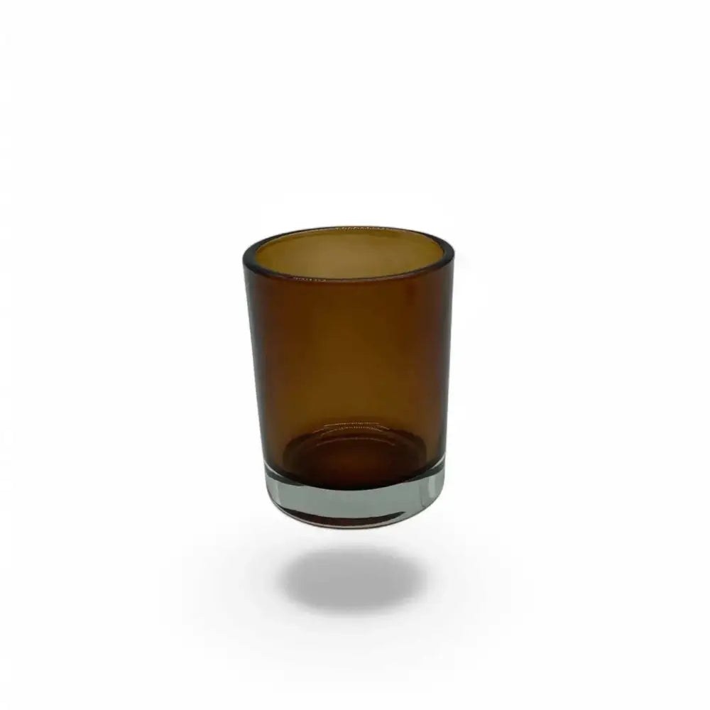 Amber glass votive candle holder, 7cm tall, 5cm diameter, ideal for creating a cozy ambiance.