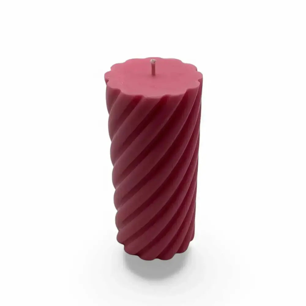 Honeysuckle scented soy spiral pillar candle with pink color and elegant design.