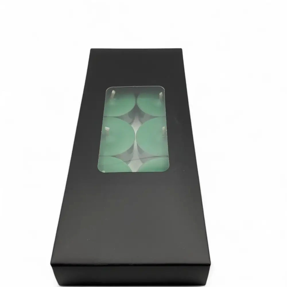 Black box containing a 10 pack of Scented Tealight Candles with a clear window showing green candles inside.