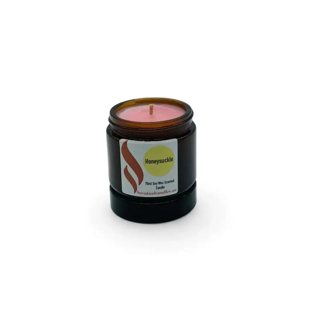 Set of 4 mini soy candles in amber jars with floral scents.