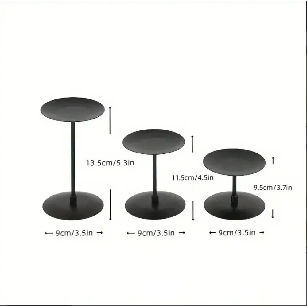 Three piece matte black wrought iron candle stands in varying heights.