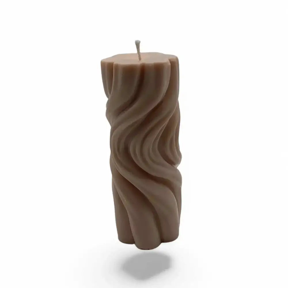 Vanilla scented soy wavy pillar candle with artistic texture and elegant design.